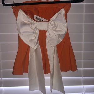 Orange and white tank top with white now on back